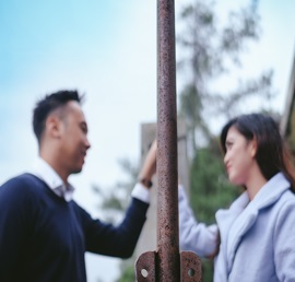 A photo of a man and woman staring at each other